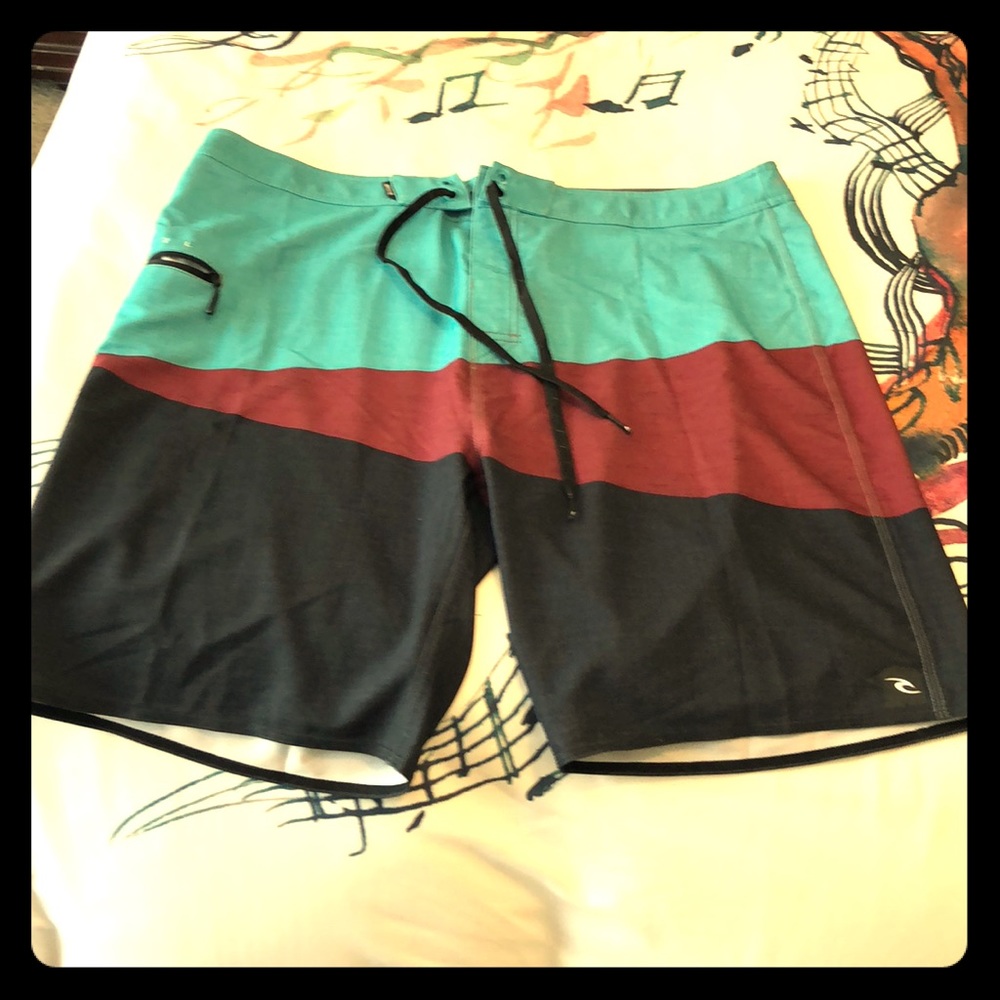 Men’s Rip Curl board shorts or swimsuit